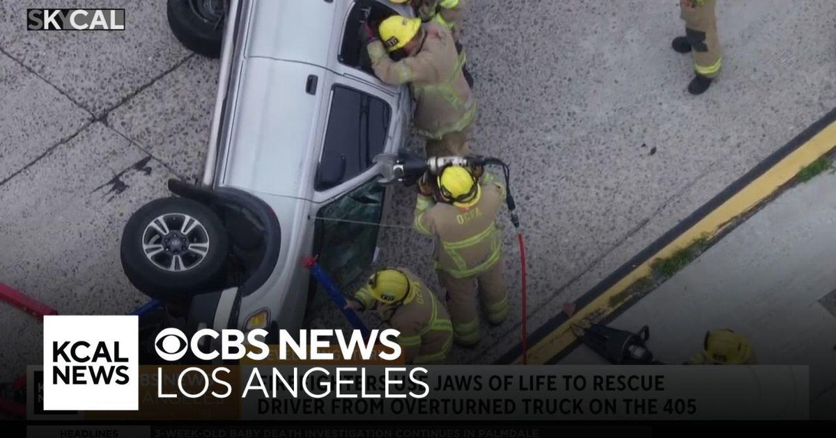 Firefighters rescue driver from overturned truck on 405 Freeway - CBS ...