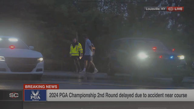 In this still image made from video provided by ESPN, Masters champion Scottie Scheffler is escorted to a police car after being handcuffed near Valhalla Golf Club, the site of the PGA Championship golf tournament, early May 17, 2024. 