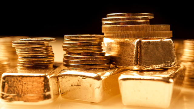 Gold bullions and stack of coins. Background for finance banking concept. Trade in precious metals. 