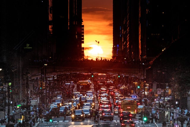 A partially cloud obscured Manhattanhenge sun set. 