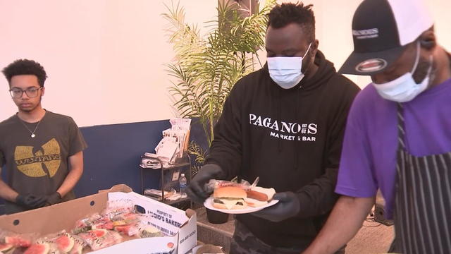 People serve food for a Memorial Day barbecue at Chosen 300 Ministries in Philadelphia 