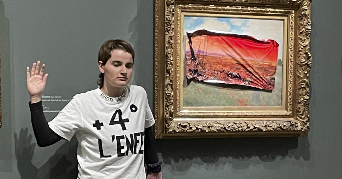 Environmental activist sticks protest poster to famous Monet painting in Paris