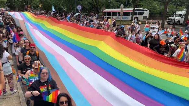 Several people hold the record-breaking pride flag in Philadelphia 