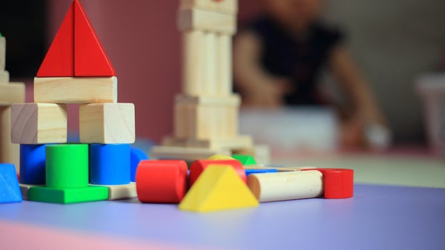 blurred baby playing toy in a playpen. 