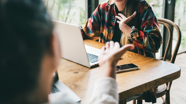 Unrecognizable people in the middle of a dynamic brainstorm an argument 