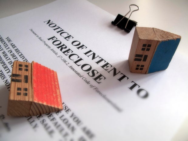 Foreclosure notice and toy houses