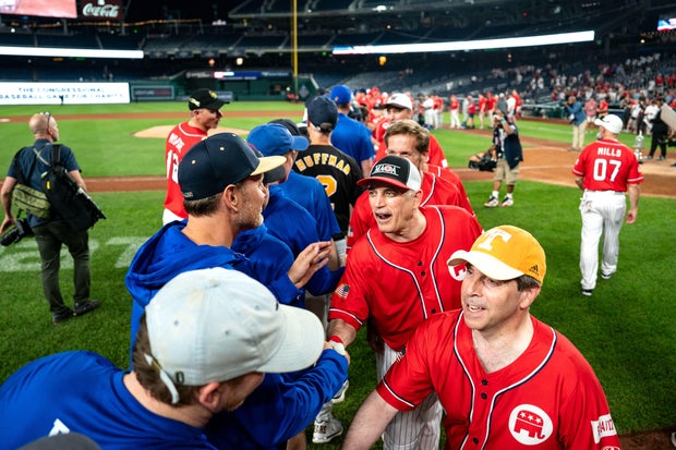Members of the Democrat and Republican teams shake hands following the Congressional Baseball Game for Charity at National's Park on June 12, 2024 in Washington, DC.