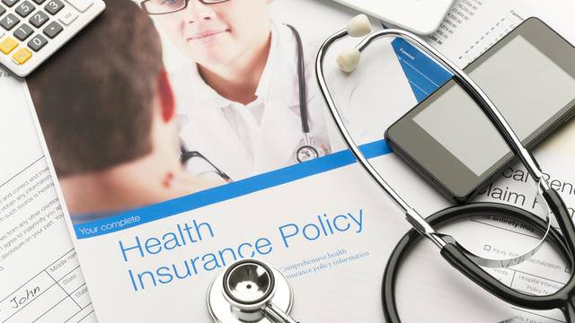 Health Insurance Policy brochure with paperwork. 