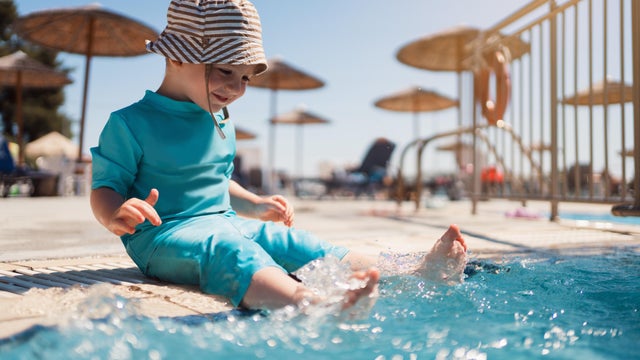 Toddler boy enjoying a day at the swimming pool 