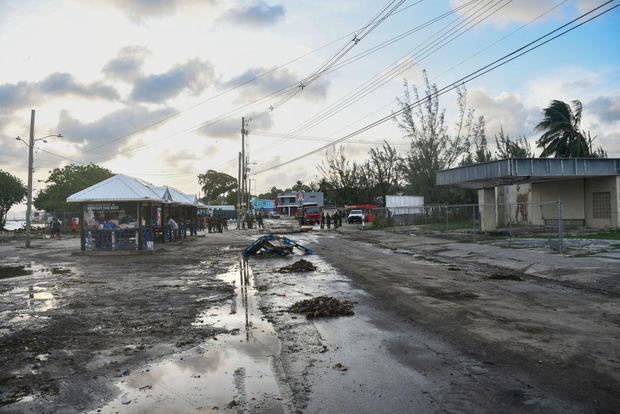 Debris and puddles are seen on a road after Hurricane Beryl tore through Christ Church, Barbados this month 