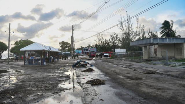Debris and puddles are seen on a road after Hurricane Beryl tore through Christ Church, Barbados this month 