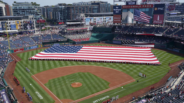 A general view as an American flag is laid out in the outfield during the National Anthem before a game between the Washington Nationals and the New York Mets at Nationals Park on July 04, 2024 in Washington, DC. 