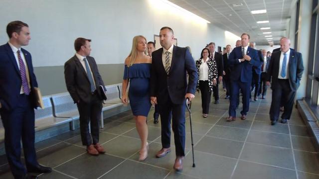 Suffolk County Police Officer Michael LaFauci and his wife leave a Long Island courtroom on July 11, 2024, after the sentencing hearing for the man who shot LaFauci in May 2023. 
