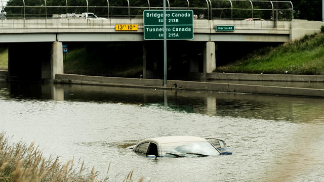Car remains inundated in floodwaters on a flooded portion of 
