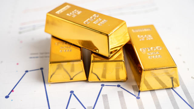 Gold bar on graph, economy finance exchange trade investment concept. 