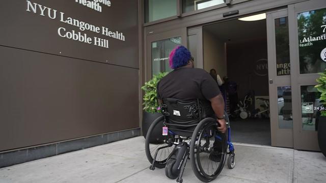 Dustin Jones pushes his wheelchair into NYU Langone Health Cobble Hill. 