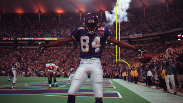 Randy Moss has a quiet moment before jumping into the estatic crowd to celebrate this fourth-quarter touchdown placing the Vikings in the lead 27-23. He caught a 45-yard pass from Daunte Culpepper. 