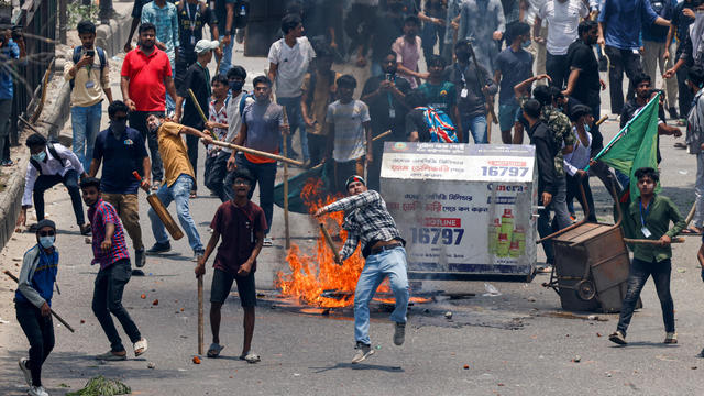 Anti-quota supporters clash with police and Awami League supporters at the Rampura area in Dhaka 