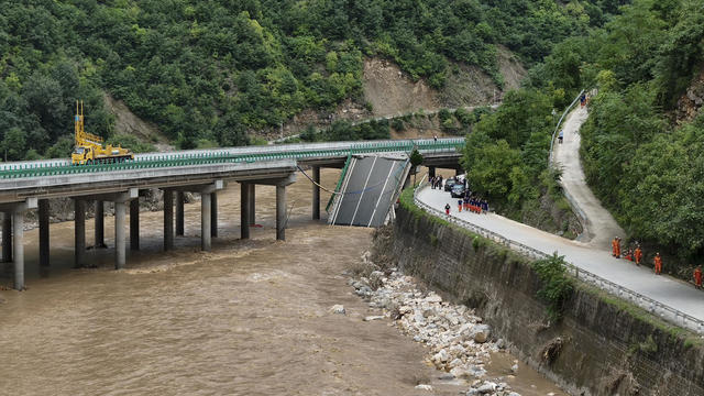 At least 11 dead, dozens missing after a highway bridge in China collapses after heavy storms