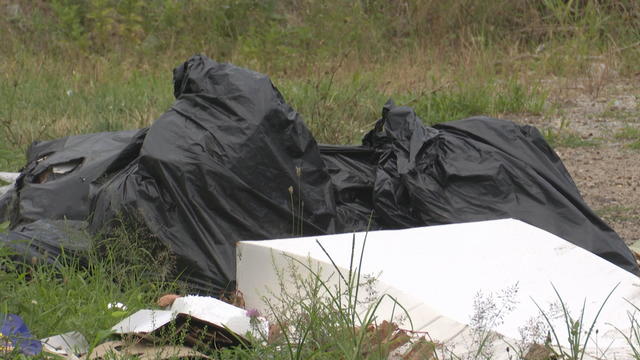 A pile of trash bags and other debris is seen in Camden 