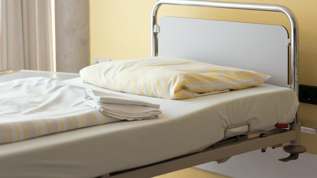 Fresh prepared empty bed in a Hospital near bright window 