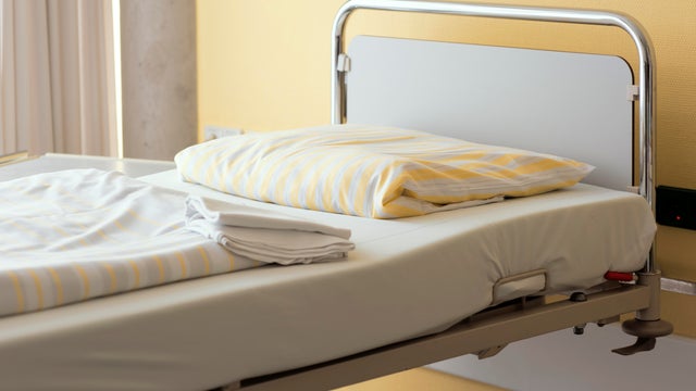 Fresh prepared empty bed in a Hospital near bright window