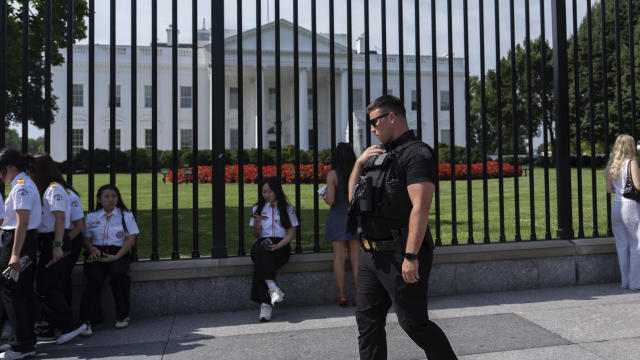 A member of the Secret Service patrols outside the White House on Tuesday, July 23, 2024, in Washington. 