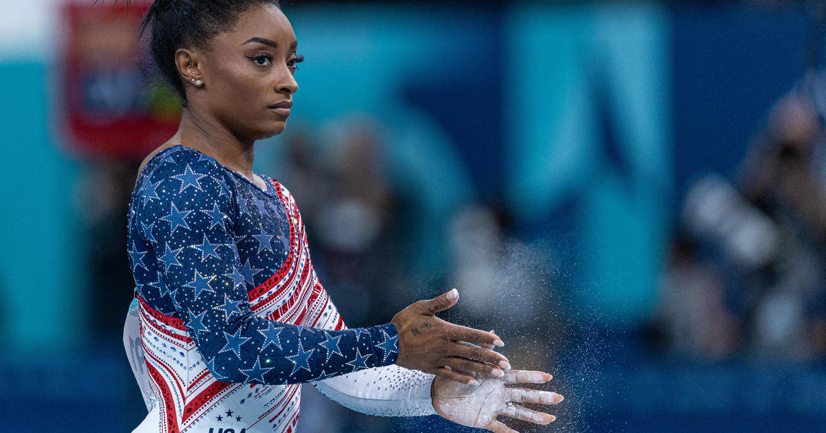 Simone Biles appears to take aim at former teammate after winning team gold - CBS News