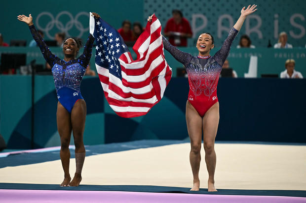 Simone Biles and Suni Lee celebrate after winning Olympic medals in gymnastics 
