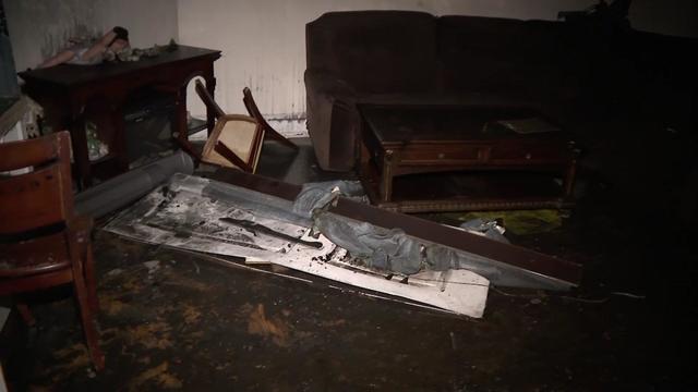 Debris and fire-blackened interior of a Queens Village home 