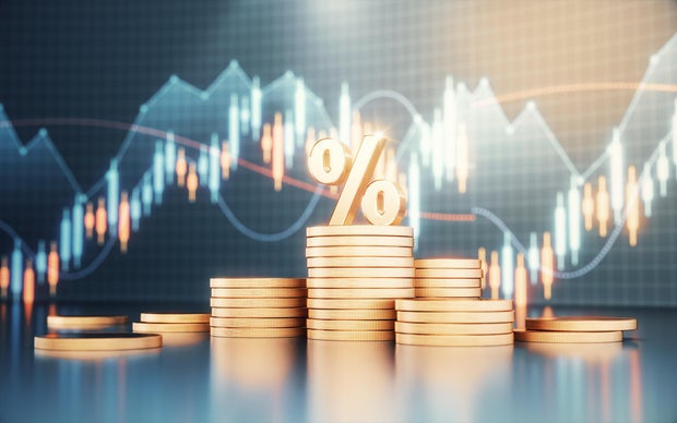 Percent Sign Standing on Metal Coins on Finance Background