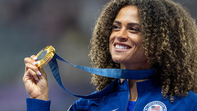 Gold medalist Sydney McLaughlin-Levrone of Team United States celebrates on the podium during the Women's 400m Hurdles medal ceremony on day fourteen of the Olympic Games Paris 2024 at Stade de France on August 09, 2024 in Paris, France. 