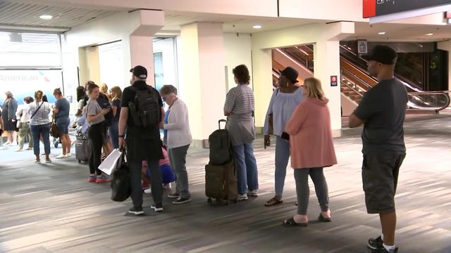 American Airlines travelers waiting for their bags at Philadelphia International Airport 