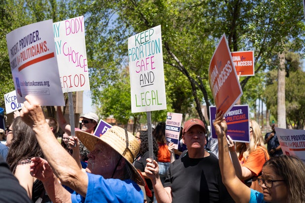 Members of Arizona for Abortion Access, the ballot initiative to enshrine abortion rights in the Arizona state constitution, hold a press conference and protest on April 17, 2024, in Phoenix.