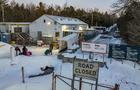 An officer speaks to migrants as they arrive at the Roxham Road border crossing in Roxham, Quebec, Canada, on March 3, 2023. 