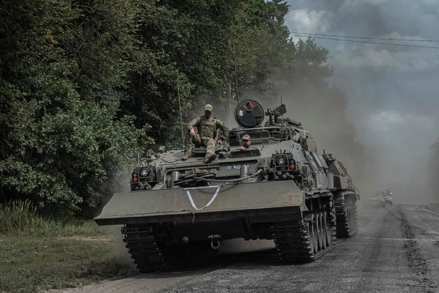 FILE PHOTO: Ukrainian servicemen ride a military vehicle near the Russian border in Sumy region 