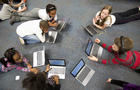 Fourth grade students work on laptops in class. 