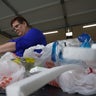 Brandy Deason sorting through plastic waste 