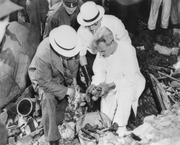 Detectives examining the bones of two murder victims of the Cleveland Torso Murderer 