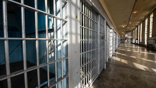 sun and shadows form on the bars of a prison 