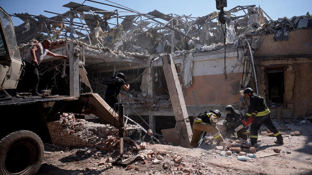 Ukrainian emergency personnel work among the rubble of a destroyed hotel following a Russian strike, in Kramatorsk 