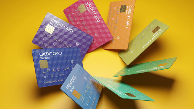 Rainbow colors of credit cards positioned in circle. Illustration of the concept of credit card overspending and consumerism 