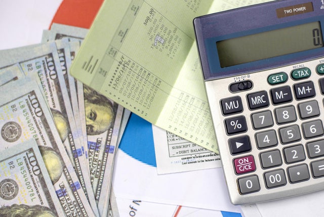 debt collection and tax season concept with deadline calendar remind note,coins,banks,calculator on table, background ,time to pay concept 