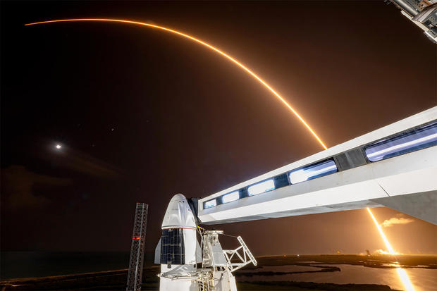 A time exposure photo captures the fiery trail of a Falcon 9 rocket climbing away from the Cape Canaveral Space Force Station early Wednesday on a flight to deploy 21 Starlink internet satellites.