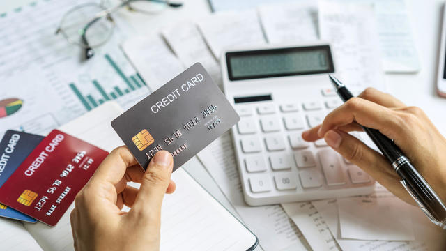 Stressed young woman calculating monthly home expenses, taxes, bank account balance and credit card bills payment, Income is not enough for expenses 