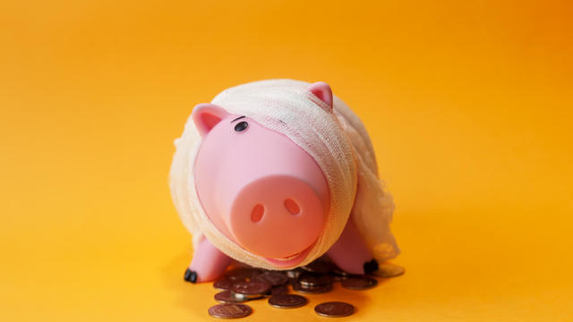 poor injured piggy bank toy 