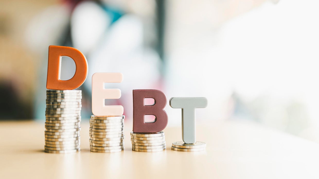 The letters of the word debt are placed on the table, the concept of the debt of the people, countries all over the world is increasing.