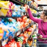 woman shopping in supermarket snack food aisle 