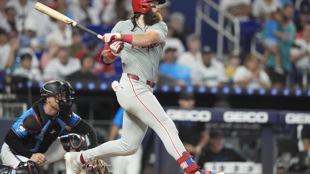 Brandon Marsh follows through on a single during the sixth inning of a baseball game against the Marlins in Miami 