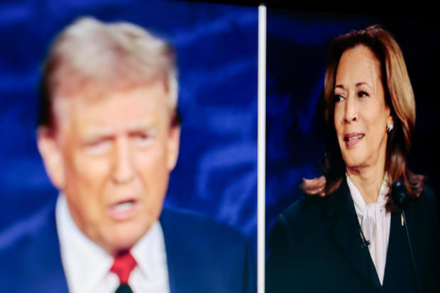 Former President Donald Trump and Vice President Kamala Harris are shown on screen in the spin room during the second presidential debate in Philadelphia on Tuesday, Sept. 10, 2024. 